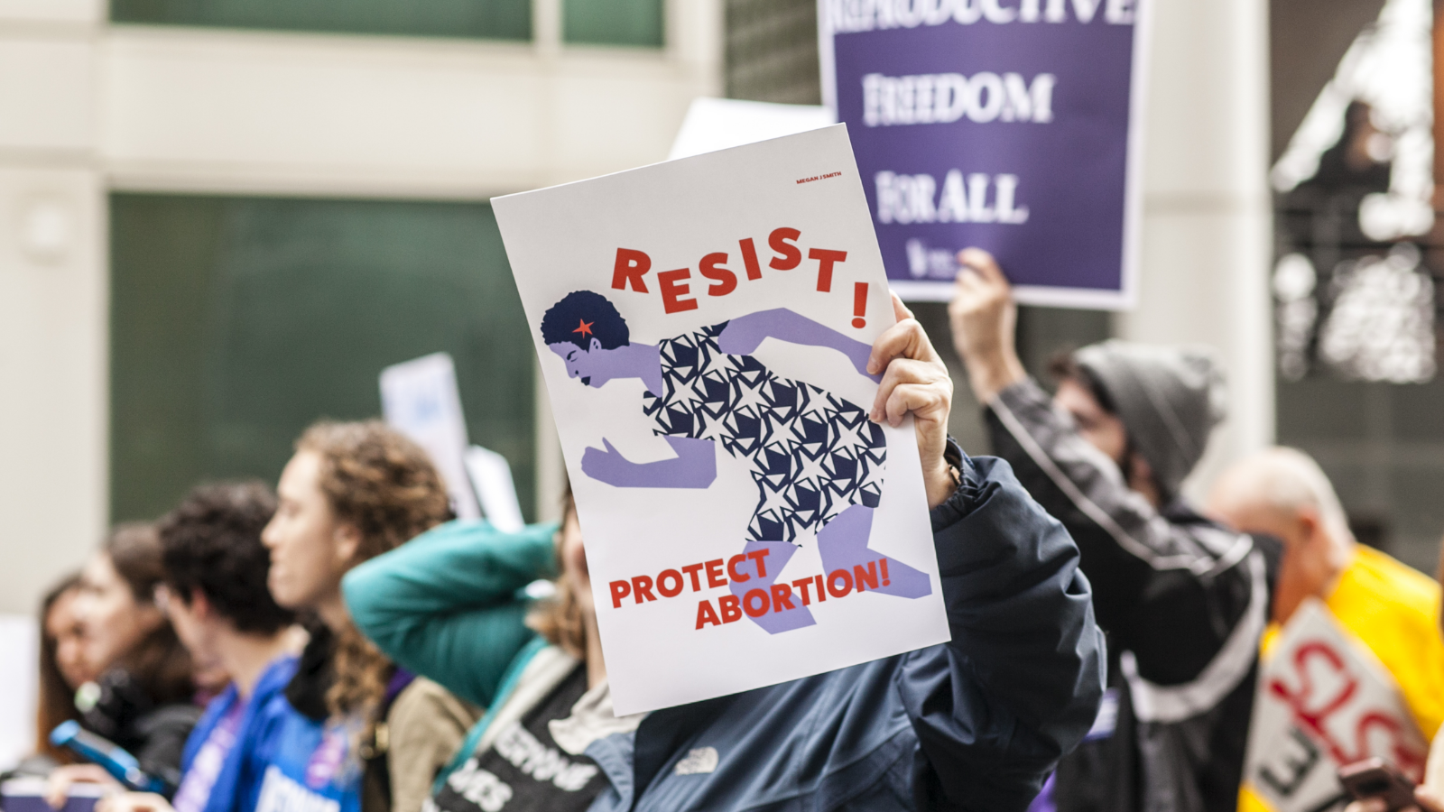 protesters holding signs