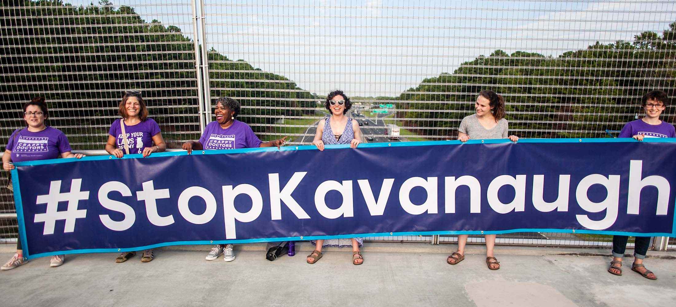 Pro-Choice NC activists holding #StopKavanaugh banner